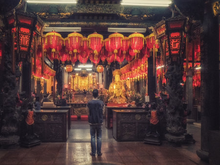 Taipei, Taiwan, 28 February 2018; A man praying in a temple at Shilin, Taipei, Taiwanのeditorial素材