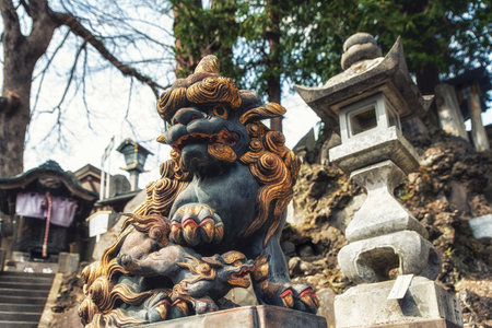 Narita, Japan 17 March, 2018: An ornately carved statue of a lion. The Narita-san temple, also known...