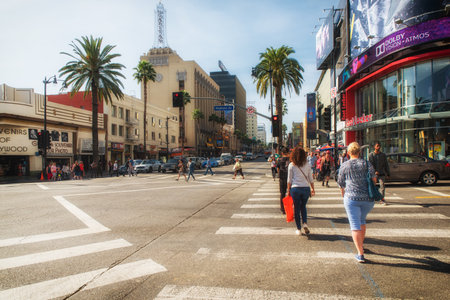Los Angeles, CA, USA - February 02, 2018: Pedestrians cross traffic on Hollywood Boulevard at daytime. The road serves as a theater district and major tourist attraction.のeditorial素材