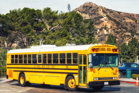 Los Angeles, CA, USA - February 02, 2018: Yellow school bus with hollywood hills in the backgroundのeditorial素材