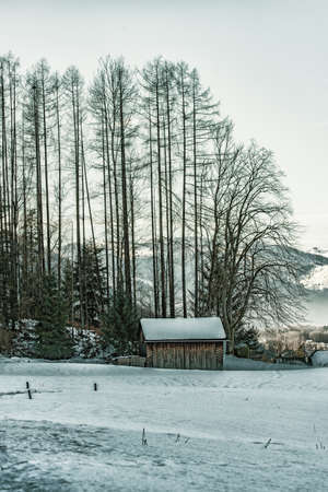 A small hut in winter landscapeの写真素材