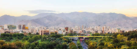 Skyline of Tehran, Iran with high rise buildings against mountains.の写真素材