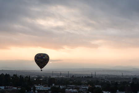 Hot air balloon flying at sunrise in Mexicoの写真素材