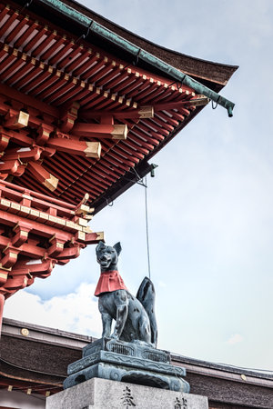 Kyoto, Japan - December 28, 2018:  Fox sculpture (Kitsune) holding a jewel in its mouth  at the main gate of the Fushimi Inari shrine, the foxes regarded as the messengers, Fushimi-ku.のeditorial素材