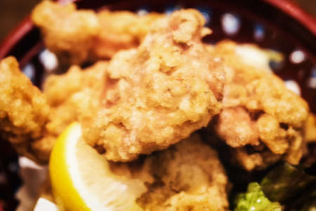Portion fried chicken karaage with lemon  close-up on a plate