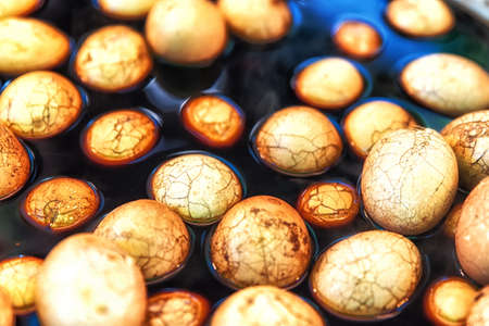 Tea egg is a typical Chinese savory food commonly sold as a snack, in which a boiled egg is cracked...