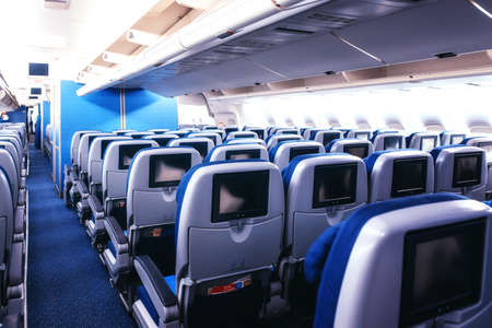 Empty airplane seats in the cabin.