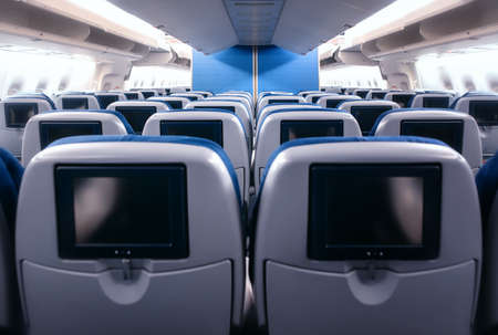 Empty airplane seats in the cabin.
