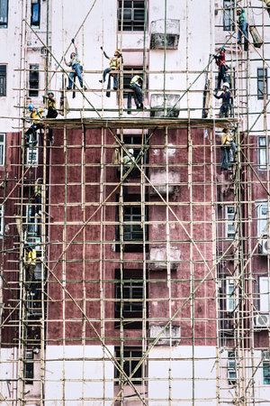 Hong Kong, China - June 26, 2019 : Workers are maintaining old building in Hong Kong.のeditorial素材