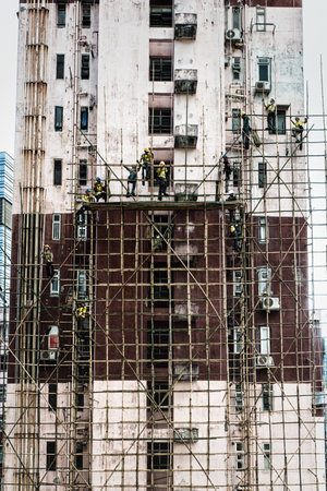 Hong Kong, China - June 26, 2019 : Workers are maintaining old building in Hong Kong.のeditorial素材