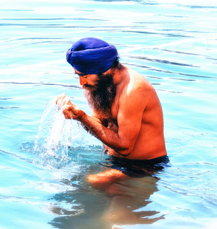 Amiritsar Punjab, India - 12 March 2019: Sikh devotee, local man bathing in the pool at Golden...