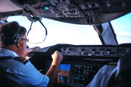 Inside cockpit of commercial airplane, Pilot approaching the landing runway.