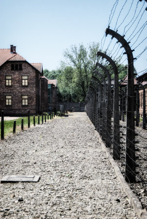 Barracks and barbed wire in a concentration camp in Auschwitz (Poland).Museum Auschwitz - Birkenau.Barbed wire around a concentration camp.のeditorial素材
