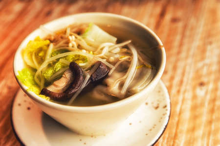 Traditional Chinese noodles in soup with vegetables.の写真素材
