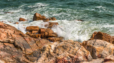 Rocky sea coast and water in Shek O,Hong Kongの写真素材