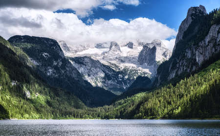 Dachstein mountain summit as seen from the crystal clear Gosausee in summer, Salzkammergut region,...