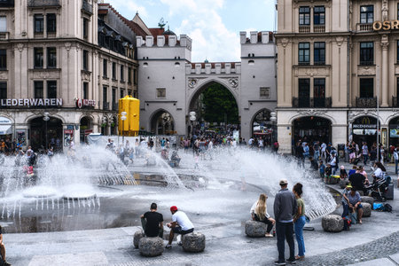 Munich, Germany - August 01, 2019:  Karlsplatz (Stachus), Munich, Bavaria, Germany, a bustling place with a fountain and historic buildings, like the Karlstor gothic gate.のeditorial素材