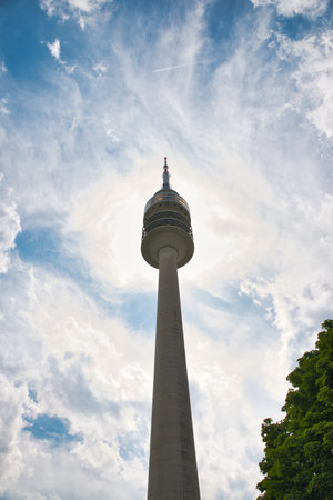 Olympic Tower or Olympiaturm close-up, Munich. Detail of top with revolving restaurant on blue sky...