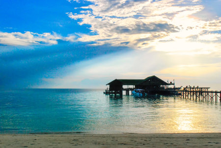 Landscape shot of rustic pier or jetty and boat at sunset, Turtle Island, Sabah, Malaysia (Borneo)