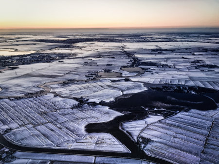 Rural landscape, Farmfield covered in snow, The Netherlands from above.