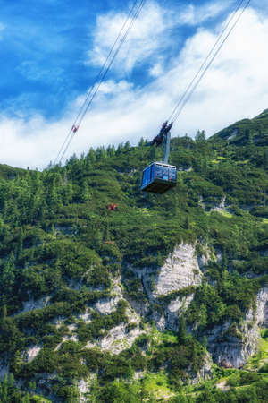 Summer vacation in the Austrian Alps Krippenstein, gondola cable car with mountain, forests.の写真素材