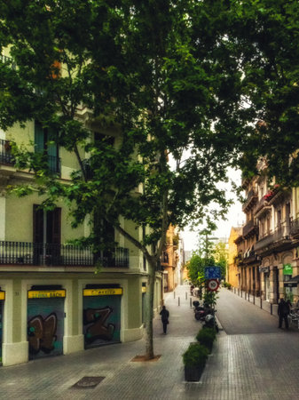 Narrow street surrounded by medieval buildings at gothic district in barcelona city, spainの写真素材