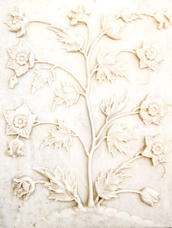 Intricate detail of white carved marble panel at Taj Mahal