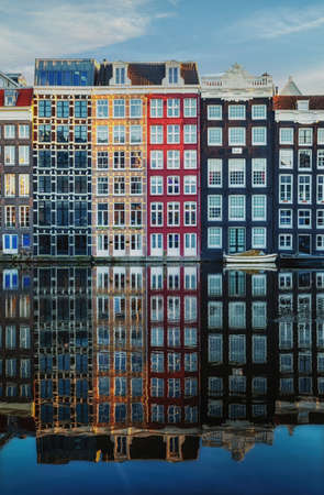 Amsterdam City Scene,  typical dutch houses and their reflection in the canal. Old 17th and 18th century brick houses along a canal in centre of Amsterdam, Netherlands.の写真素材