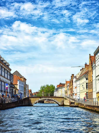 Water canal in Bruges, Belgium showing the bridges to which the city ows its nameの写真素材