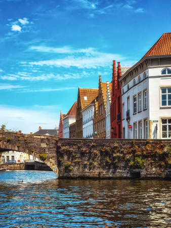 Water canal in Bruges, Belgium showing the bridges to which the city ows its nameの写真素材