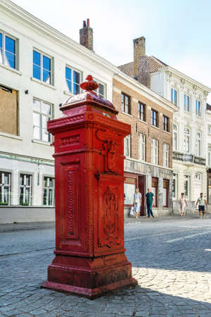 A typical traditional red mailbox, standing in the Belgian city of Bruges. Belgium