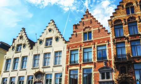 Traditional colorful Belgian facades of houses with tiled roofs in Bruges.のeditorial素材