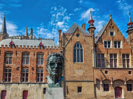 Bruges, Belgium - May 15 2022 : Bronze Sculpture statue of Frank Van Acker former mayor of Bruges and minister of state of Belgium by the Vismarktのeditorial素材