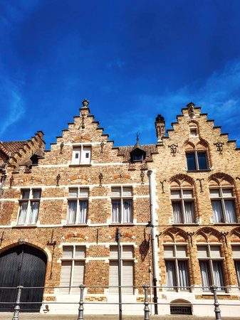 Traditional colorful Belgian facades of houses with tiled roofs in Bruges.のeditorial素材