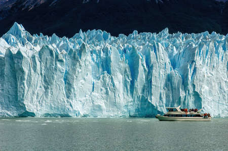 Cruise boat in front of Perito Moreno Glacier in Patagonia, Argentina, South America; guided boat tour on lakeの写真素材