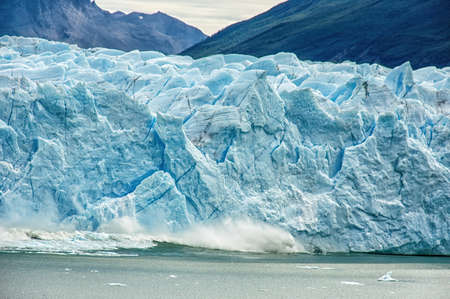 Ice Calving: A giant chunk of ice breaking off the magnificent Perito Moreno Glacier in Patagonia, Argentina.の写真素材