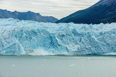 Ice Calving: A giant chunk of ice breaking off the magnificent Perito Moreno Glacier in Patagonia, Argentina.の写真素材