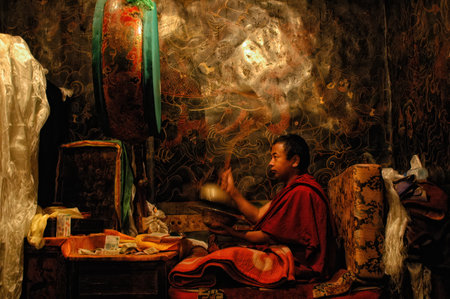 lhasa, Tibet - August 31 2007:: Tibetan monk praying on his own inside the Potala Palace in Lhasa, Tibetのeditorial素材