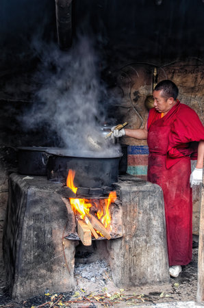 lhasa, Tibet - August 31 2007:: Buddhist monk cooking Yak milk butter for candles in monastery, Drepung monastery, Lhasa, Tibetのeditorial素材