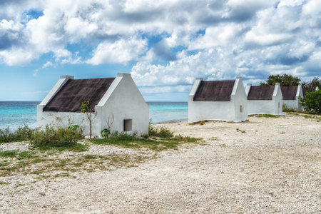 Former slave huts on the Caribbean island of Bonaire. These were built in 1850 to house slaves that worked on the salt mines.の写真素材