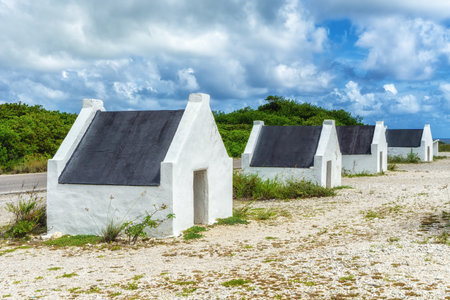Former slave huts on the Caribbean island of Bonaire. These were built in 1850 to house slaves that worked on the salt mines.の写真素材