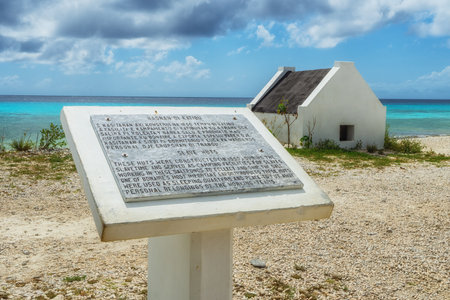 A sign located at the historic slave huts on the island tells the history of these buildings.の写真素材
