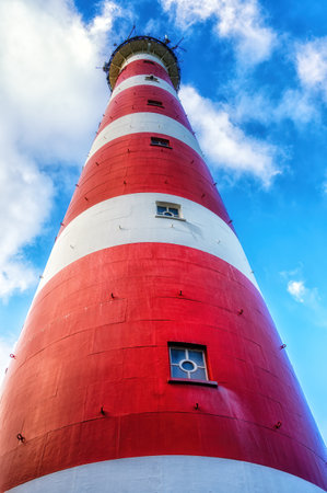 The red and white striped lighthouse of the Wadden island of Ameland in the north of the Netherlandsの写真素材