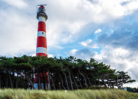The red and white striped lighthouse of the Wadden island of Ameland in the north of the Netherlandsの写真素材