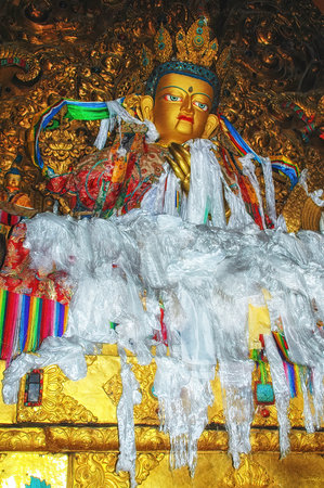 Statue the Buddhist master Guru Rinpoche who has brought the Buddhism to Tibet located in Jokhang Buddhist temple in Lhasa, Tibetのeditorial素材