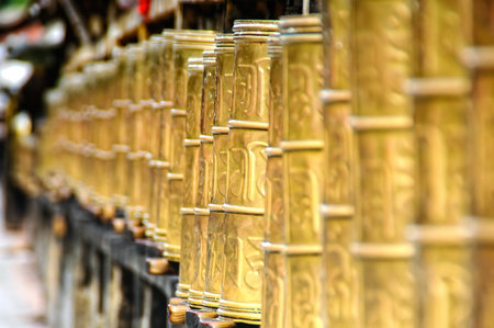 Prayer wheels in Potala palace, former Dalai Lama residence in Lhasa in Tibet. The Potala Palace is...