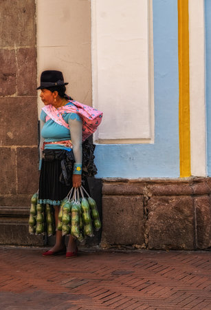 Quito, Ecuador - 24 November 2022: Traditional woman street vendor at historic center of Quito, Ecuador.のeditorial素材