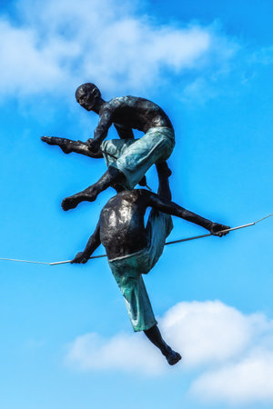 Krakow, Poland - 12 August 2022: view of acrobat iron sculptures on Bernatek pedestrian bridgeのeditorial素材
