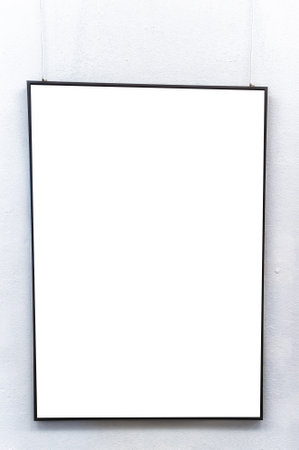 Empty picture frame hanging on white wall.の写真素材