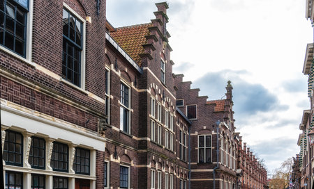 Low angle view of traditional Dutch houses in historic center of Haarlem, The Netherlandsの写真素材